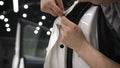 The master sticks a white protective film on the car body. Wrapping a car body with a white protective film. nstallation