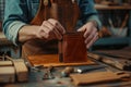 Master tanner in his leather workshop working on a leather wallet