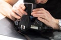 Master to clean the photosensor examines the camera matrix Royalty Free Stock Photo
