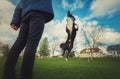 Master training his obedient dog outdoors in the park. Well trained healthy border collie pup jumping high in the air making Royalty Free Stock Photo