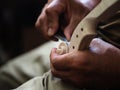 Luthier violinmaker scultping a classic violin curl