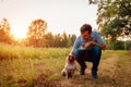 Master walking and hugging pug dog in autumn forest. Happy puppy sitting on grass. Dog love Royalty Free Stock Photo