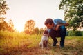 Master walking and hugging pug dog in autumn forest. Happy puppy sitting on grass. Dog love Royalty Free Stock Photo