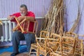 Master of wicker-work making a stool