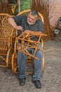 Master of wicker-work making a stool