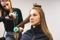 Master woman hairdresser dries the girl's hair with a hairdryer and combs after washing in the beauty salon. Royalty Free Stock Photo