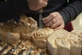 Master woodcarver at work. Wood shavings, gouges and chisels on the workbench. Royalty Free Stock Photo
