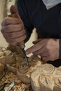 Master woodcarver at work. Wood shavings, gouges and chisels on the workbench. Royalty Free Stock Photo