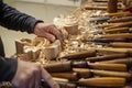 Master woodcarver at work. Wood shavings, gouges and chisels on the workbench. Royalty Free Stock Photo
