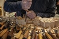 Master woodcarver at work. Wood shavings, gouges and chisels on the workbench. Royalty Free Stock Photo