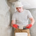 The master works with lime plaster, leveling the wall with a spatula and lime plaster.