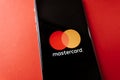 MasterCard logo on the smartphone screen, on red background