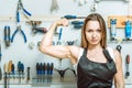 Masterful craftswoman demonstrating her biceps in the workshop