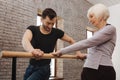 Masterful dancer instructing pensioner in the dance studio