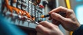 Masterful electrician skillfully works on circuit panel using precise tools for safe and effective repairs Royalty Free Stock Photo
