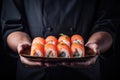 Masterful sushi chef serving freshly prepared rolls