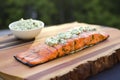 Masterfully prepared salmon, arranged on a cedar board.