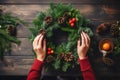 Mastering the art of Christmas wreath-making. A woman showcases her holiday creation