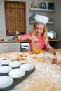 MAstering the basics of baking. a little girl baking in the kitchen. Royalty Free Stock Photo