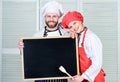 Mastering cooking skills. Couple of man and woman holding empty blackboard in cooking school. Master cook and prep cook