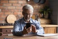 Focused senior man pensioner hold mobile phone dial number