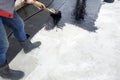 Masters perform work on the waterproofing of concrete in the open air Royalty Free Stock Photo