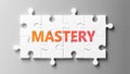 Mastery complex like a puzzle - pictured as word Mastery on a puzzle pieces to show that Mastery can be difficult and needs Royalty Free Stock Photo