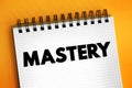 Mastery - comprehensive knowledge or skill in a particular subject or activity, text concept on notepad