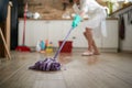 Mastery in Motion: A Woman's Skillful Command with the Mop in Focus