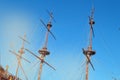 The masts of an ancient sailing ship with lowered sails in front of the blue sky and bright sunlight Royalty Free Stock Photo