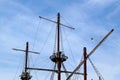 Masts of an ancient ship without sails against a cloudy sky Royalty Free Stock Photo