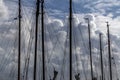 Masts in a harbor with impressive cloudy skies in the background