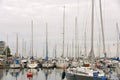 Masts of many sailing boats and yachts on cloudy sky background Royalty Free Stock Photo