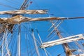 Masts of an old sailing ship with rolled up white sails Royalty Free Stock Photo