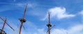 Masts of an old sea vessel without sails against a blue sunny sky, copy space Royalty Free Stock Photo