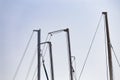 Masts of sailing ships yacht on blue sky background in marina Royalty Free Stock Photo