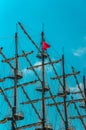 The masts were rigged by an old pirate boat excursion against the blue sky. Numerous crowds of tourists make a sea voyage through Royalty Free Stock Photo