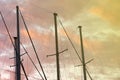 Masts Of A Yacht Without Sails Against The Background Of A Sunset Cloudy Sky