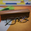 Masunaga eyeglasses with its leather case on a tabletop in front of a keyboard