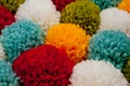 Mat of pompons made from multi-colored handmade yarn Royalty Free Stock Photo