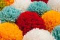 Mat of pompons made from multi-colored handmade yarn Royalty Free Stock Photo