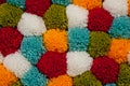 Mat of pompons made from multi-colored handmade yarn Royalty Free Stock Photo