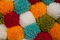 Mat of pompons made from multi-colored handmade yarn Royalty Free Stock Photo
