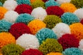 Mat of pompons made from multi-colored handmade yarn Royalty Free Stock Photo