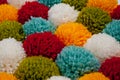 Mat of pompons made from multi-colored handmade yarn Royalty Free Stock Photo