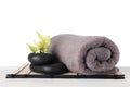 Mat with towel, spa stones and exotic flower Royalty Free Stock Photo