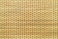 Mat from yellow wood bamboo sticks with brown thread