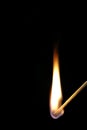 Match flame on black background. Royalty Free Stock Photo