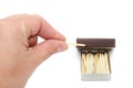 Match in hand on white and box with matches Royalty Free Stock Photo