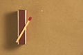A match on a pack of matches. On a craft background. Place for text. background Royalty Free Stock Photo